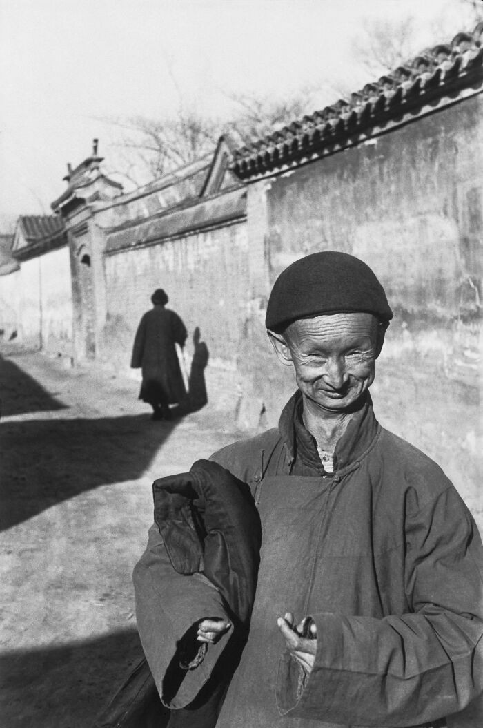 "Near The Forbidden City, A Simpleton Whose Job Is To Assist Brides In A Sedan Chair, Beijing, December 1948."