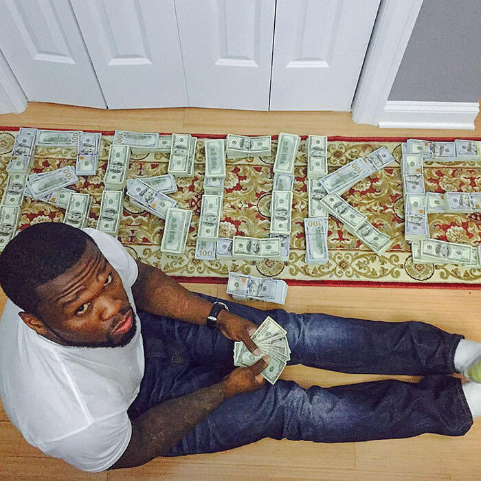 10. 50 Cent Showed Off His Wealth by Posting a Photo on Instagram and Spelling Out “Broke” in Stacks of Hundreds