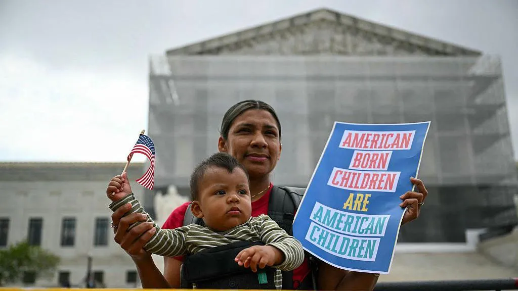 Olga Urbina and her son Ares protest outside the US Supreme Court against Trump’s birthright citizenship plan.