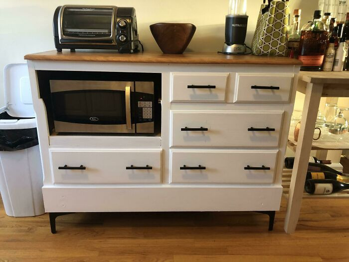 36. He transformed an old dresser into a microwave stand.