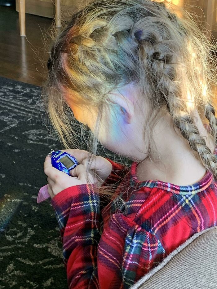37. My daughter playing with her new Tamagotchi