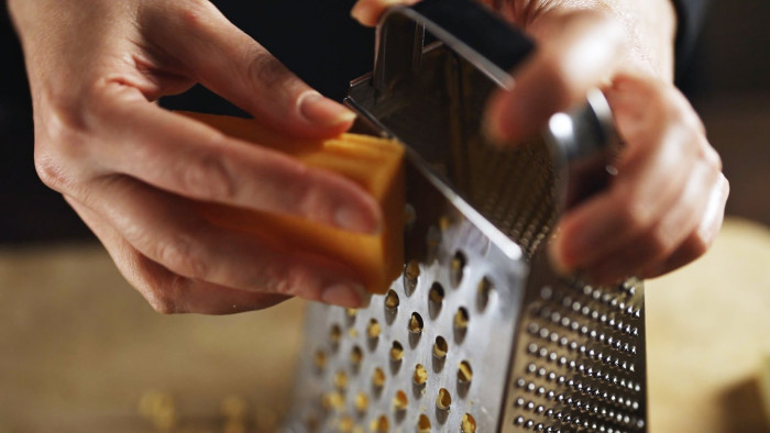 Culinary specialist holding a grater, explaining hidden uses of the fourth side