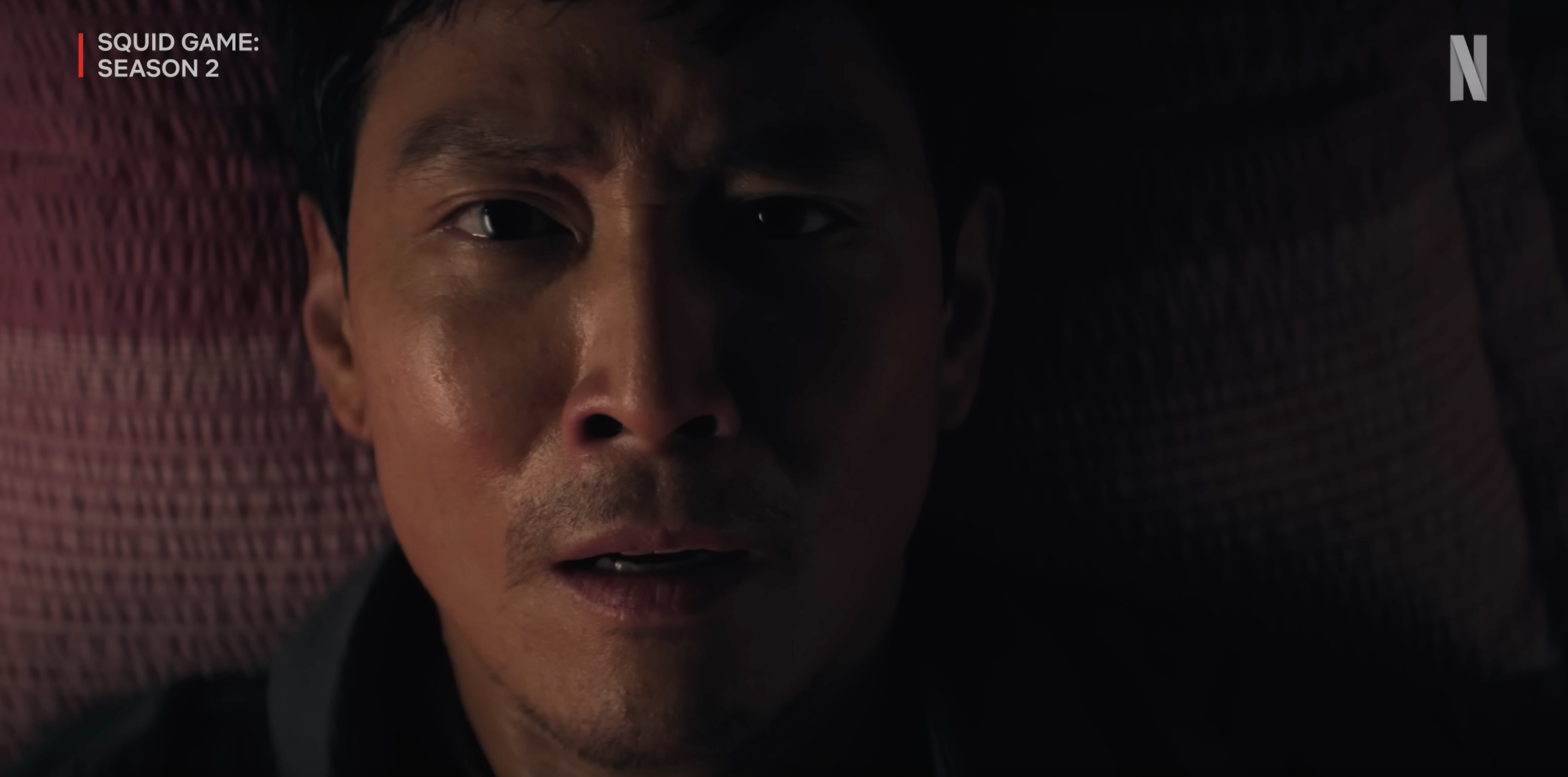 The second season's highly anticipated trailer opened with Gi-hun (sans red hair) seemingly woken by an unexpected knock on his door.