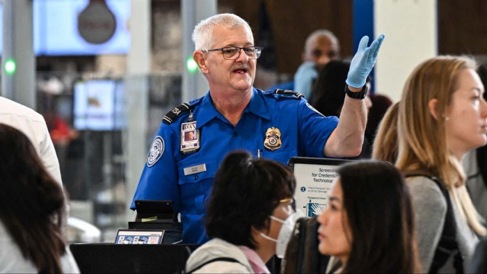 Boston Logan Airport arrivals area, warning travelers about reported measles case