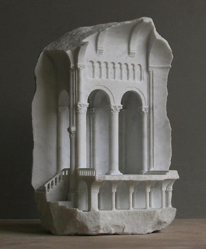 Small stone sculpture resembling a hidden temple, smooth surfaces, quiet scale.