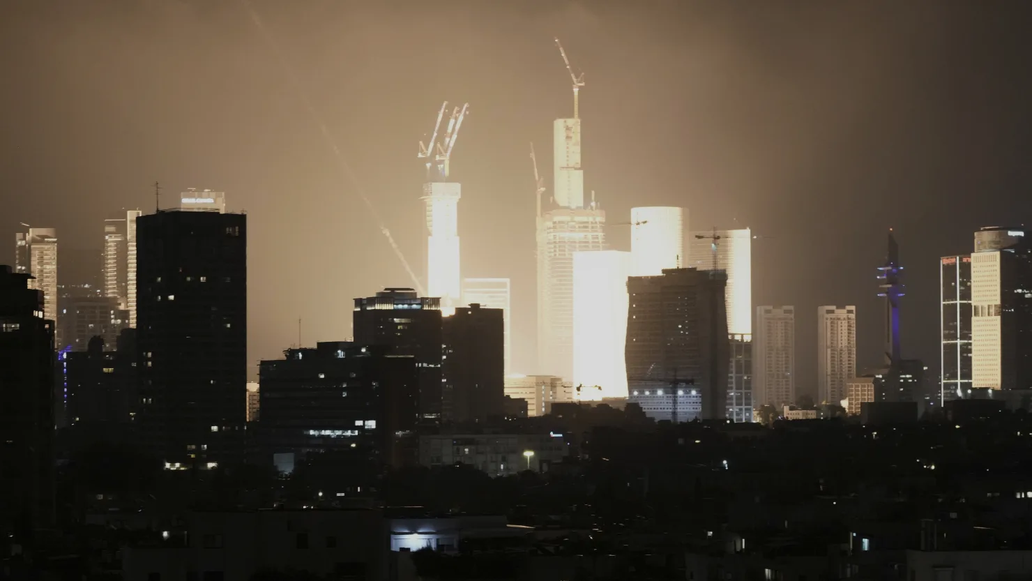 A projectile strike lights up the Tel Aviv skyline in a bright explosion early Saturday, June 14, 2025.