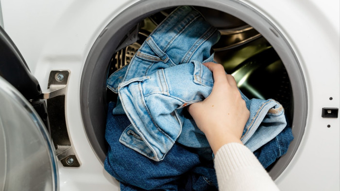 Jeans cleaning guidance emphasizing washing less to prevent sagging and preserve fit