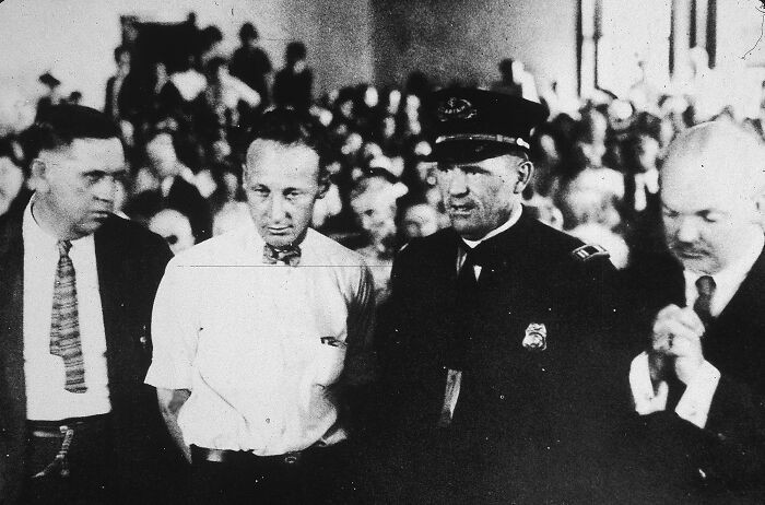 "H**h School Teacher John T. Scopes Is Brought To Trial In Dayton, Tennessee For Teaching The Theory Of Evolution, Which Was Prohibited Under State Law. July 10, 1925"