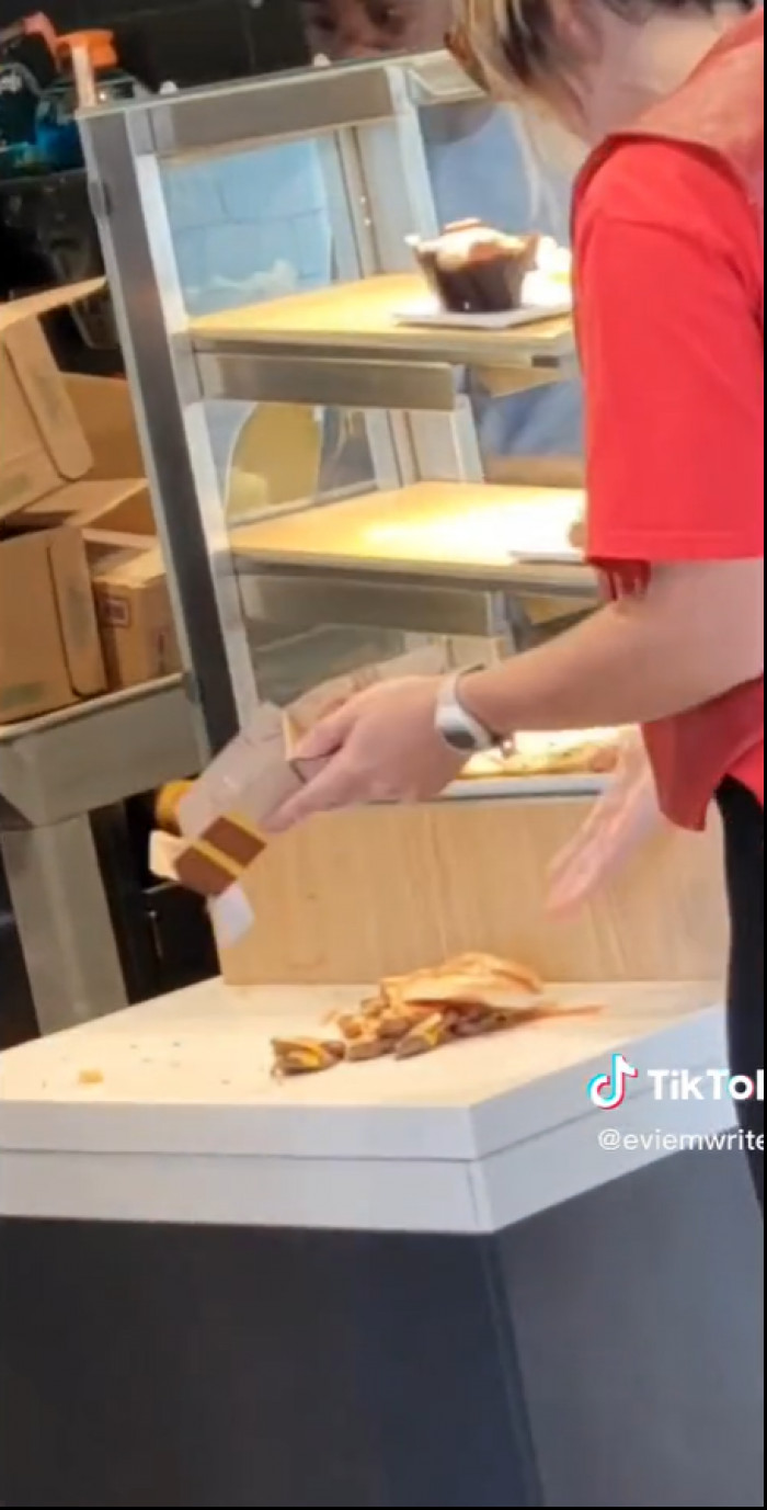 As she approaches, she shows the staff her burger. “I asked for extra ketchup, and I got—” she starts.