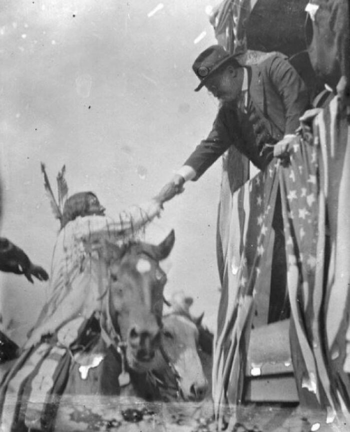 Teddy Roosevelt Shaking Hands with a Native American Man, 1912