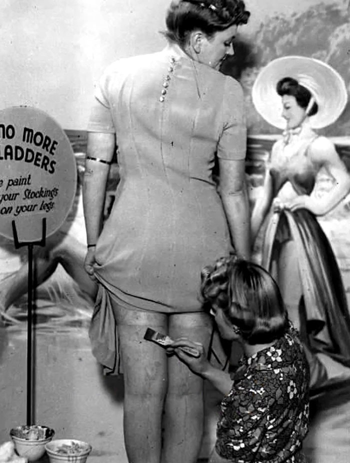 A Beautician Paints Stockings Onto A Customer's Skin During Stocking Rationing, London, England In 1941