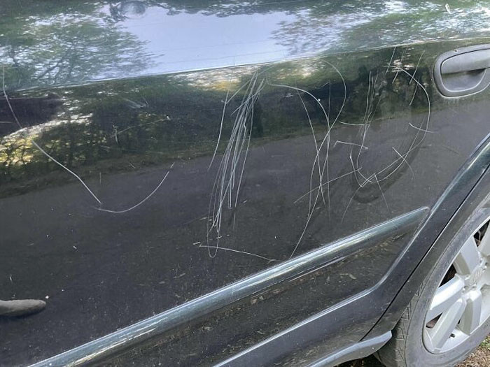 32. Some kid tried to decorate this car using a rock.