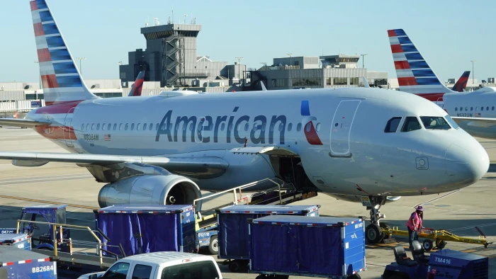 Close-up of an American Airlines aircraft exterior showing bullet marks and damage