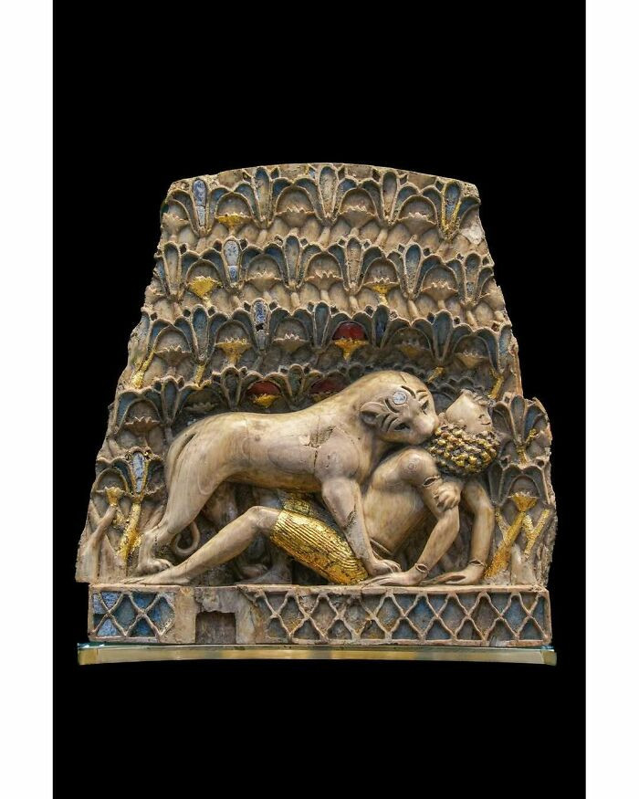 A lioness is consuming a man. Phoenician ivory, 9th–8th century BCE. Palace of Ashurnasirpal II, Nimrud.