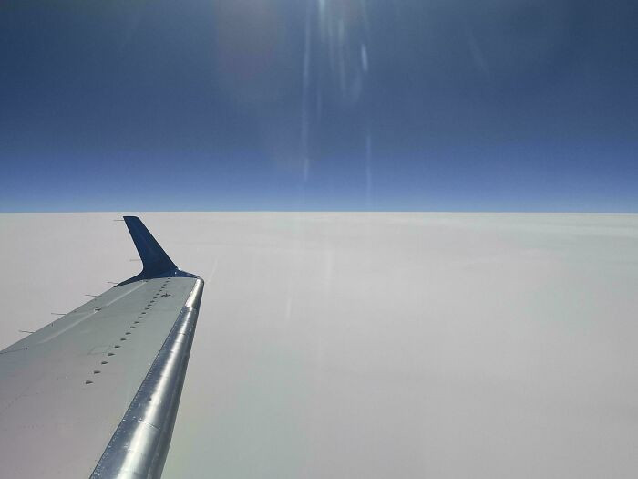 "The Clouds And Horizon Viewed From Our Airplane Appear To Be Perfectly Flat"