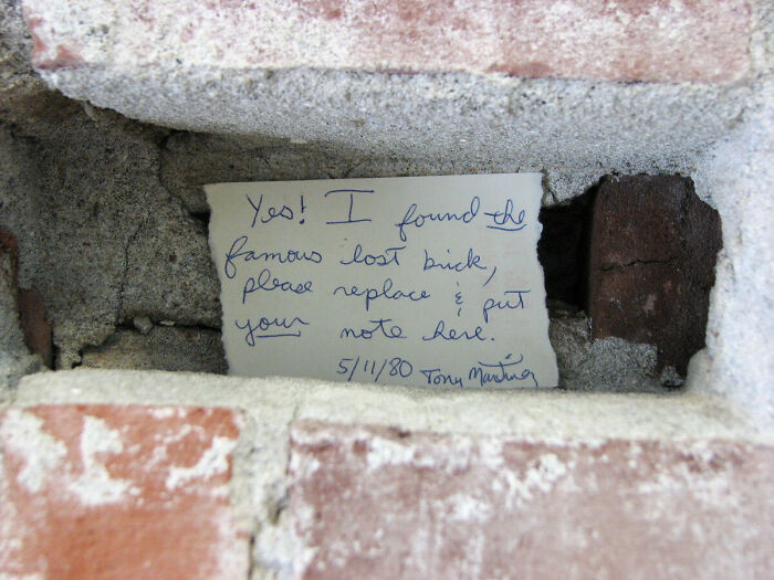 24. While re-mortaring an old brick wall, a worker found a loose brick with a note behind it written 32 years ago. They then added their name and date to it and mortared it up again.