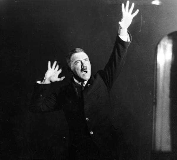 14. Adolf Hitler rehearsing his speeches in front of a mirror (1925).