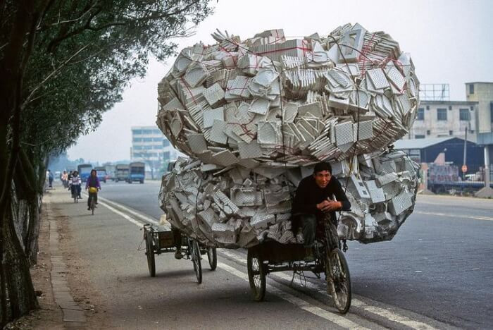 11. This man's load is bigger than his vehicle.