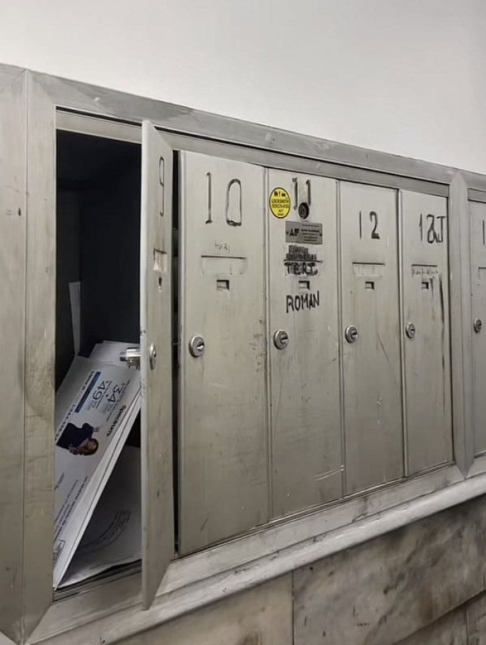 The mailboxes appear dated and filthy, and one of them doesn't seem to close.