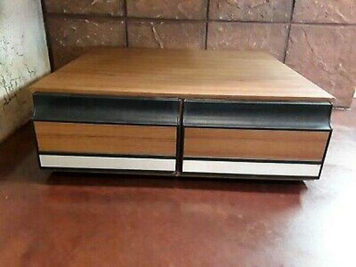 28. A wood grain pull-out VHS storage