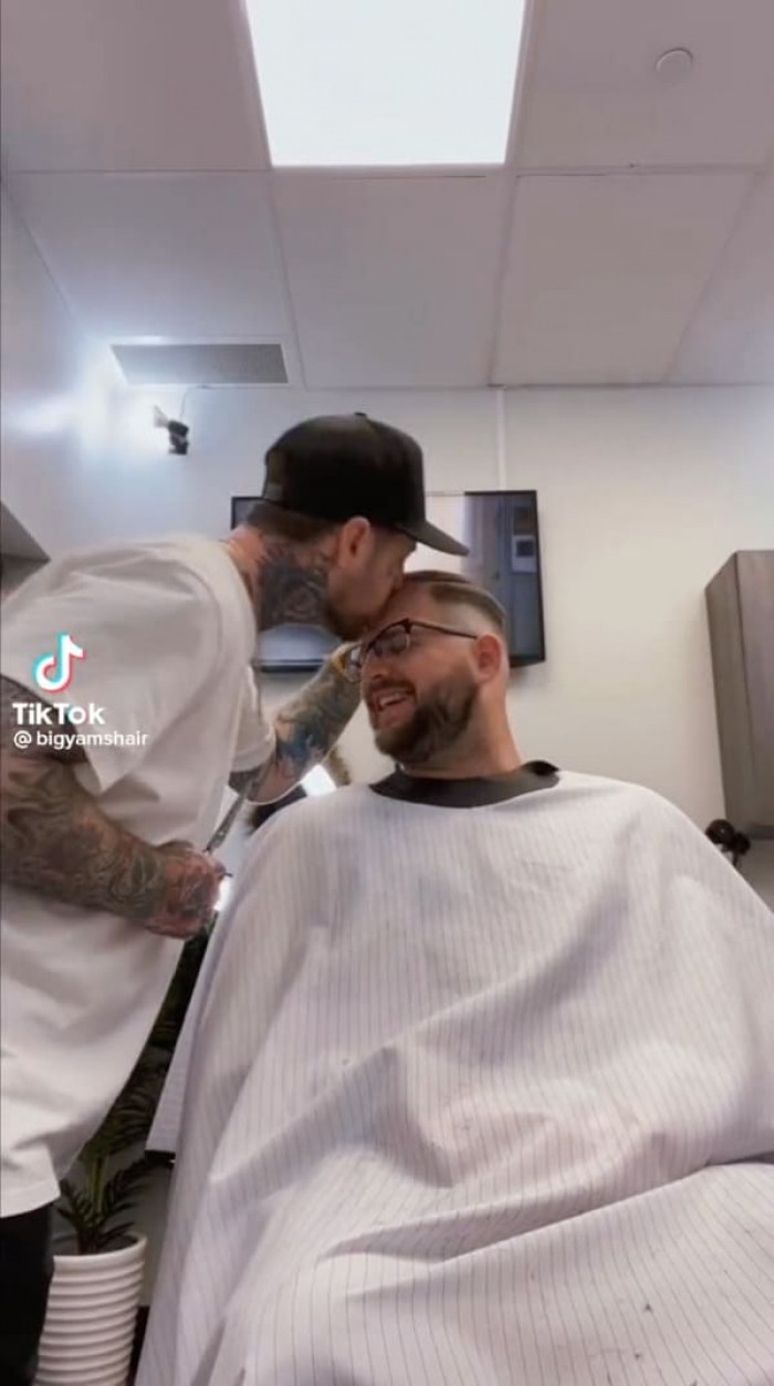 The last thing most customers would anticipate from a face-tatted New Jersey barber is a kiss on the forehead, but it's a hit with his clients.