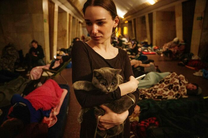 A Woman Holds Her Cat In A Metro Station Hallway As People Take Cover During A Russian Attack, Kyiv, Ukraine. Photo By Evgeniy Maloletka