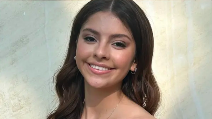 Volunteers and community members hold signs during urgent search for Camila Olmos