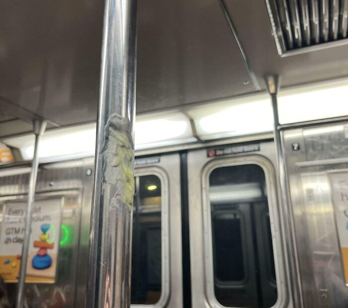 "Someone Stuck Gum On The NYC Subway Cart Pole"