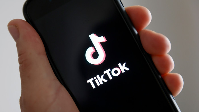 Smartphone screen showing TikTok algorithm change concerns amid U.S. and China digital security tensions.