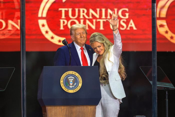 Erika Kirk speaking at a press or media event about halftime controversy