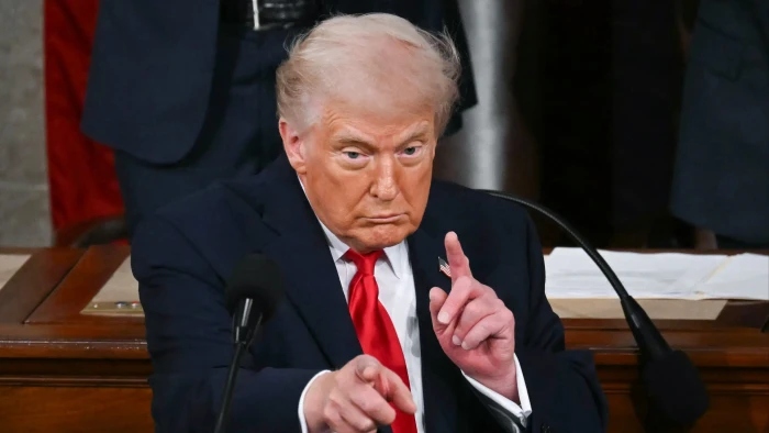 News photo showing mourners and flags, reflecting outrage over rising conflict casualties