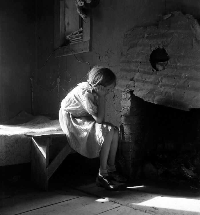 Resettled farm child moving from Taos Junction to the Bosque Farms project in New Mexico, 1935