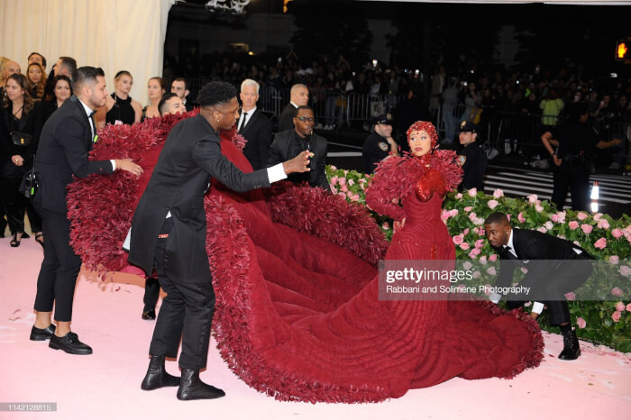 3. Cardi B wore a stunning (and massive) red gown during the Met Gala 2019, where 10 people assisted with the train while she walked on the red carpet.