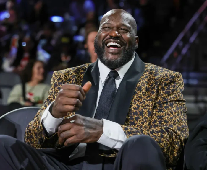 Shaquille O’Neal speaks at an event, smiling about his Olympics packing.