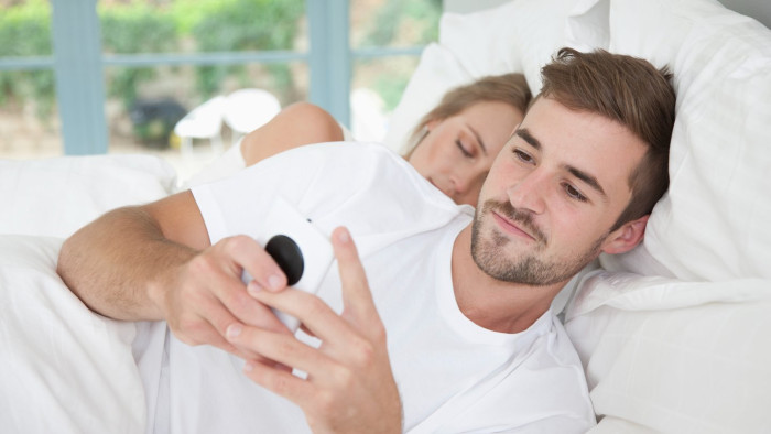 Smartphone showing dating site notifications, highlighting concerns about secret accounts and infidelity