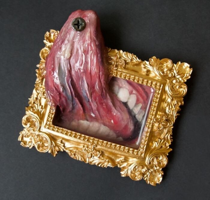"Oil on panel, clay, modeling paste, found objects, and resin in vintage frame."