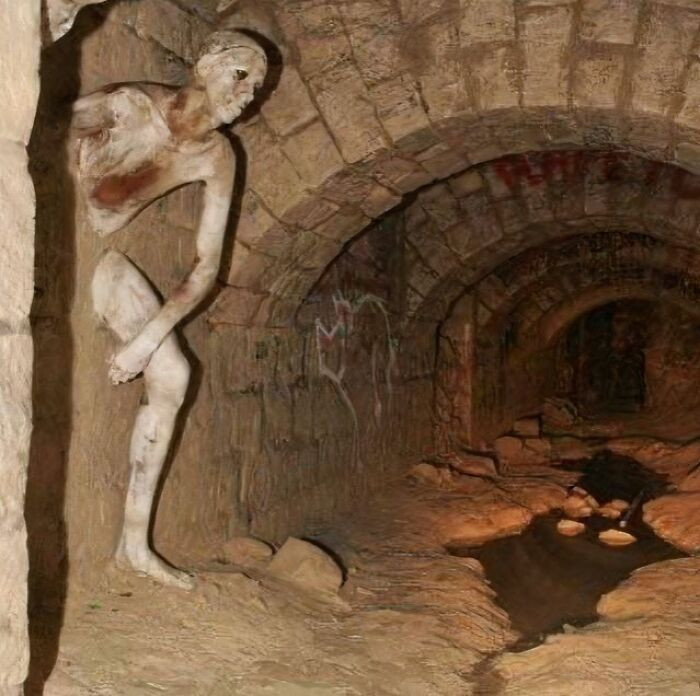 'The Passer-Through-Walls (Le Passe-Muraille) Sculpture In The Paris Catacombs'