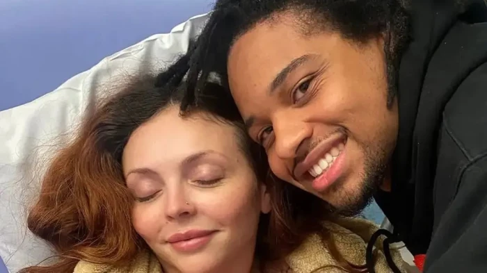 Jesy Nelson holding her belly, worried look while discussing twin health concerns