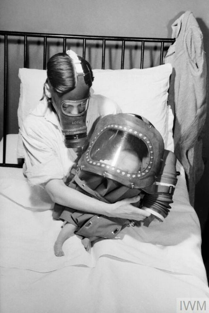"Air Raid Precautions On The British Home Front: Mother And Baby In Gas Masks, c. 1941"