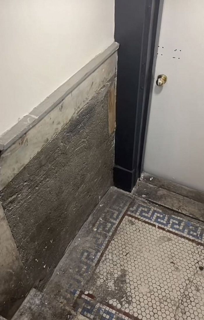 You'll also notice the damage to the floor and walls at the bottom of the steps.