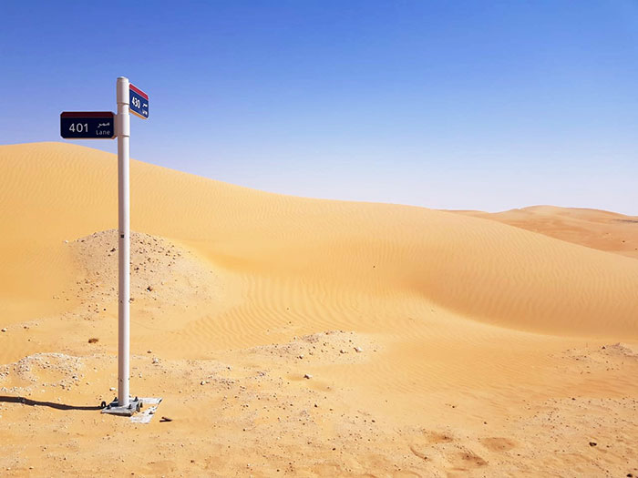 36. A Street Sign In The Desert, At An Intersection Of Two Sand Lanes