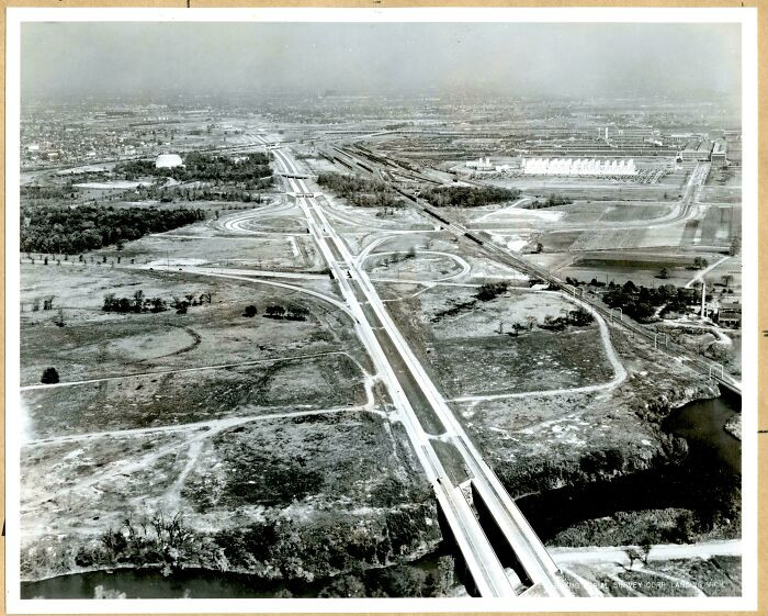 Detroit’s Industrial Expressway in the 1940s runs past the vast Ford River Rouge Plant, a snapshot of a city powered by steel, smoke, and nonstop industry.