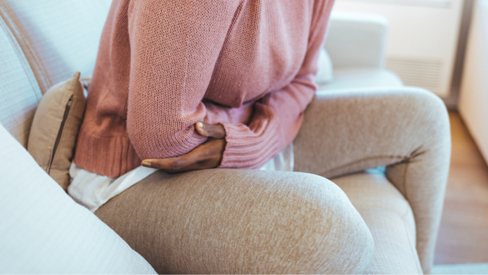 Healthcare consultation room setting, highlighting IUD insertion concerns and dismissed pain reactions