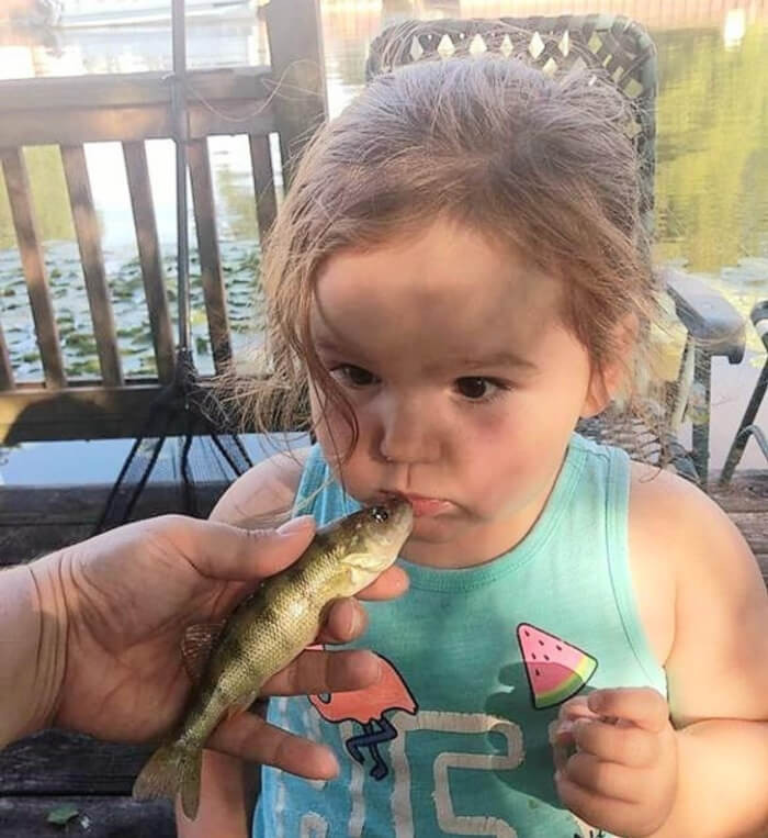 2. My niece is rethinking her decision to give the fish a kiss before throwing it back.