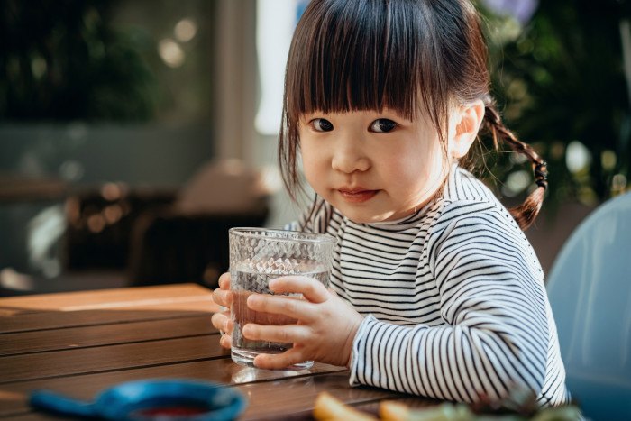 Person drinking water, highlighting hydration’s vital role for optimal health