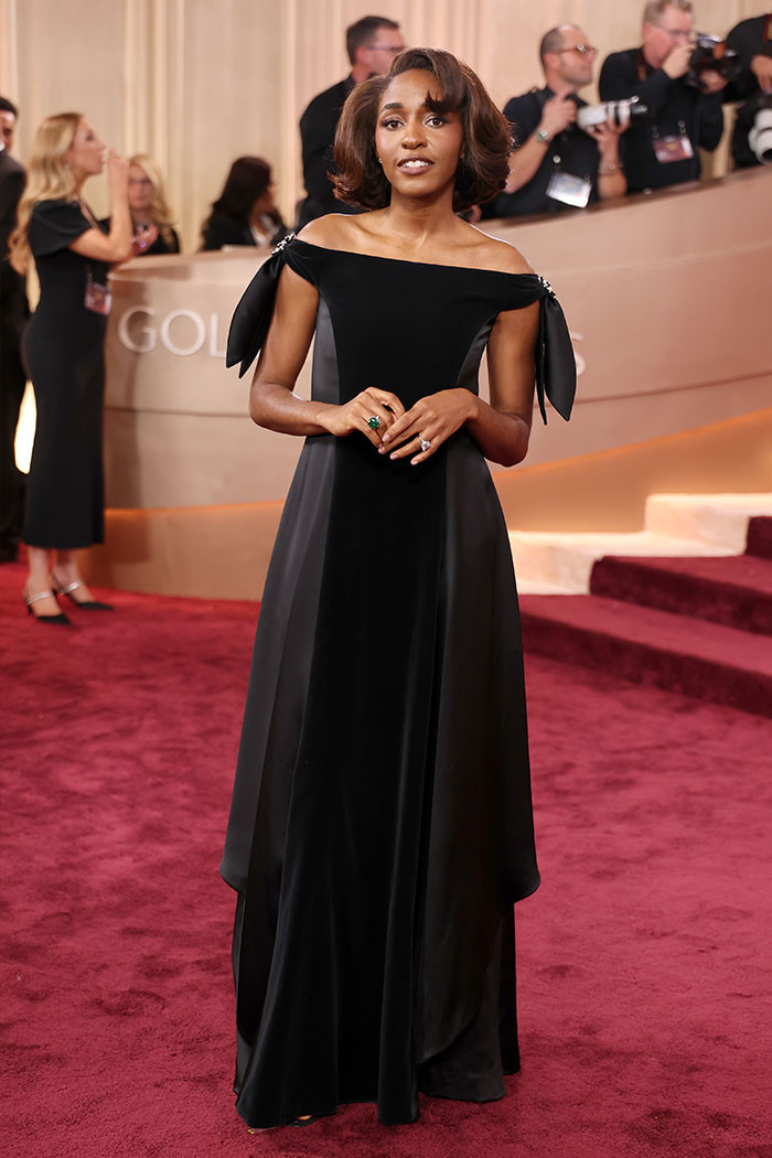 Ayo Edebiri - The Bear star turned heads in a black off-the-shoulder Chanel gown, elevating the look with bold silver and emerald brooches on her shoulders.
