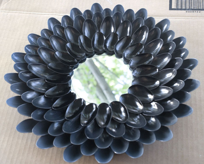 1. Using plastic spoons to create a detailed work of art... Or light