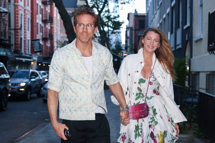 Blake Lively on a film set, speaking with Ben Affleck during production