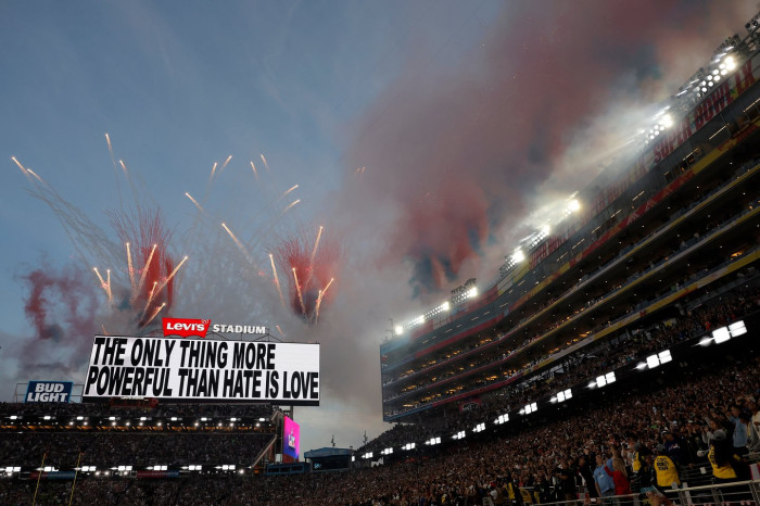 Bad Bunny performing on Super Bowl halftime stage with energetic crowd