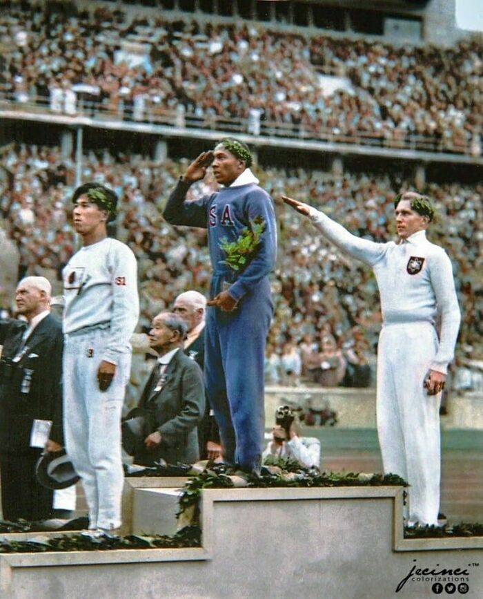 32. Jesse Owens, American Track And Field Athlete And Four-Time Gold Medalist, Salutes During The Presentation Of His Gold Medal For The Long Jump, After Defeating Nazi Germany’s Luz Long During The 1936 Summer Olympics In Berlin, Germany